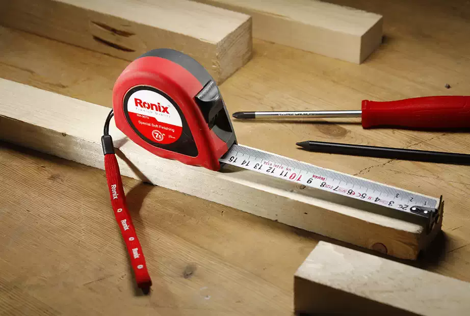 A Ronix tape measure on a piece of wood
