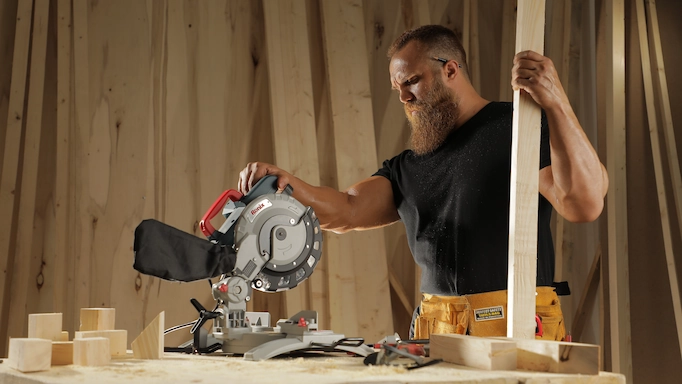A miter saw is being used to cut wood