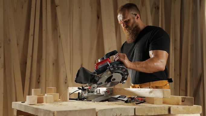 A miter saw is being used to make a miter cut