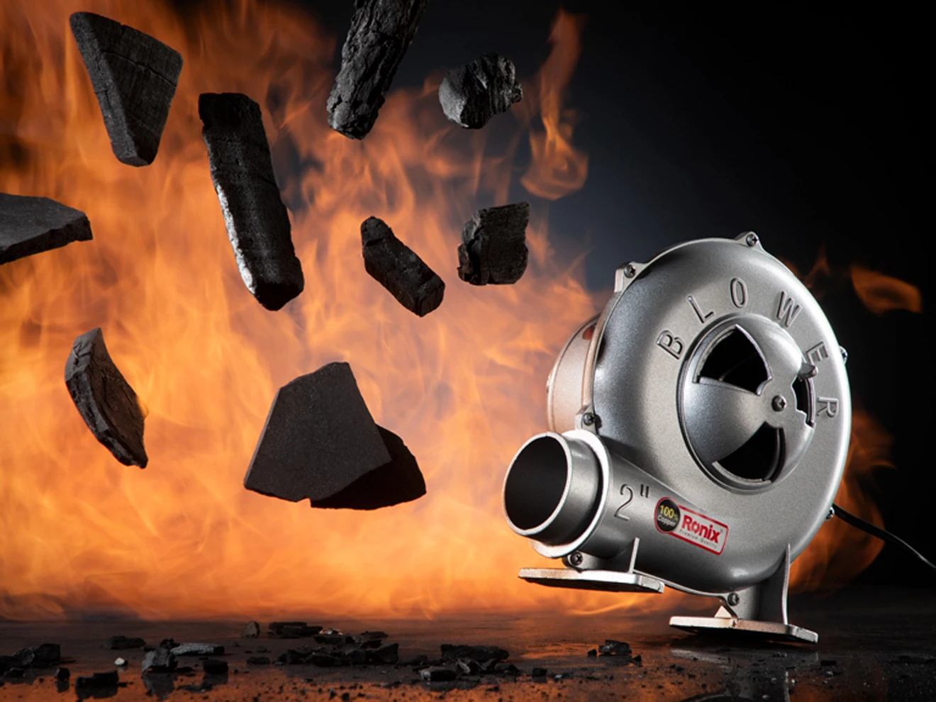 A photo of Ronix forge blower with a background of fire