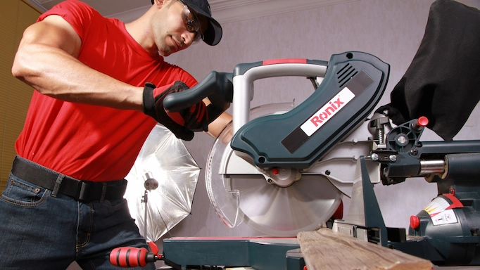 A miter saw is being used to cut wood