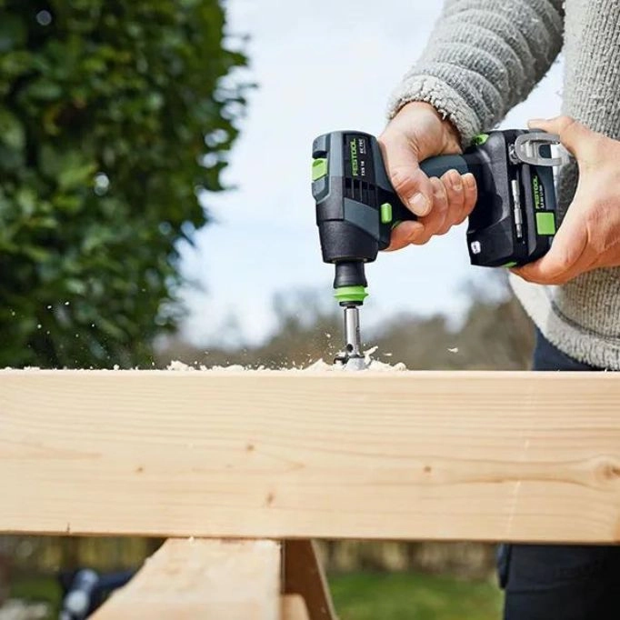 a man drilling a piece of wood with Festool Power Drill