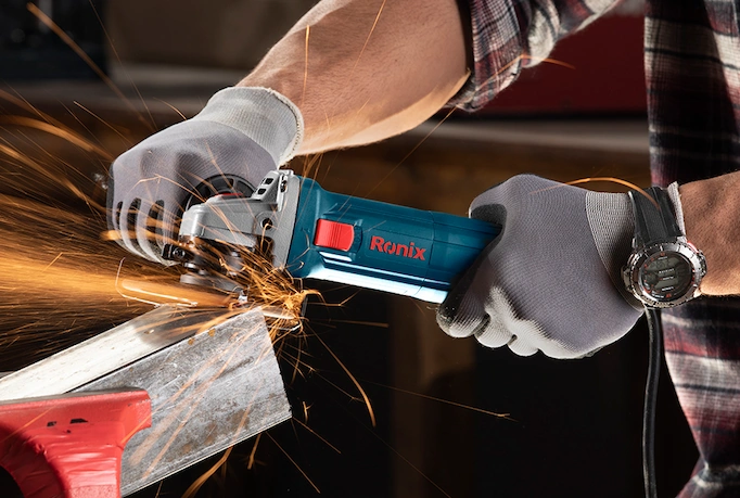 A n angle grinder is being used on a metal profile