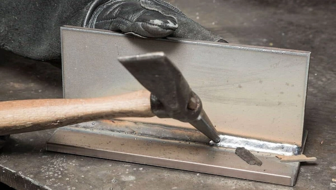 chipping hammer being used for welding