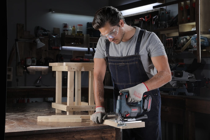 A jigsaw is being used to cut wood