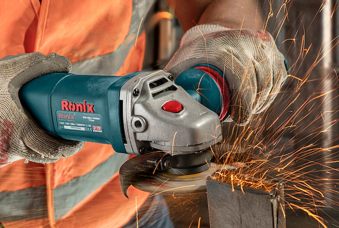 An angle grinder is being used to cut metal profile