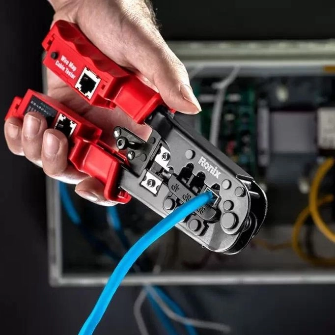 picture of a plier cutting a blue wire 