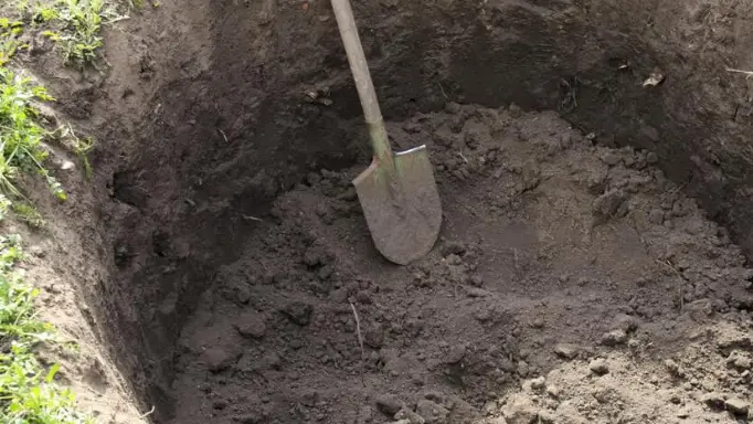 A shovel inside a recently dug well