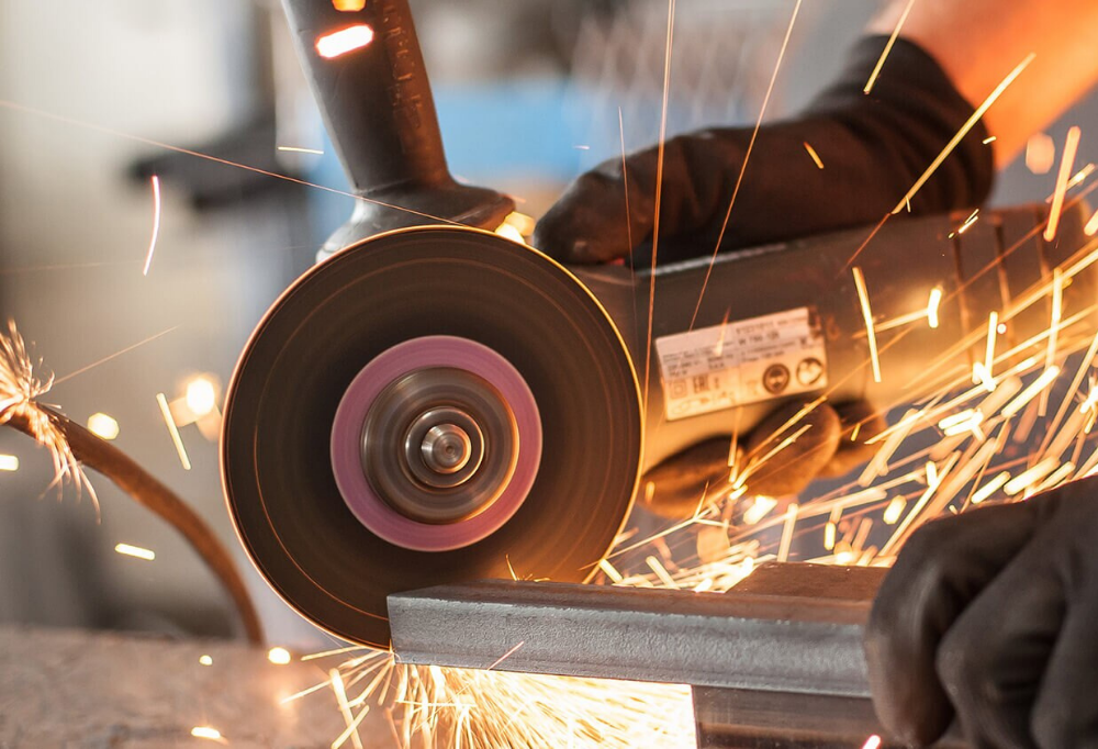 an angle grinder wheel cutting steel