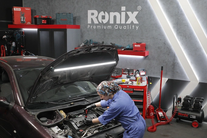 A mechanic working on a car