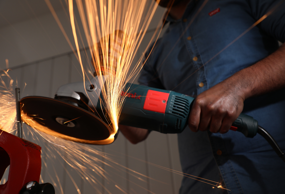 a person working with a Ronix angle grinder
