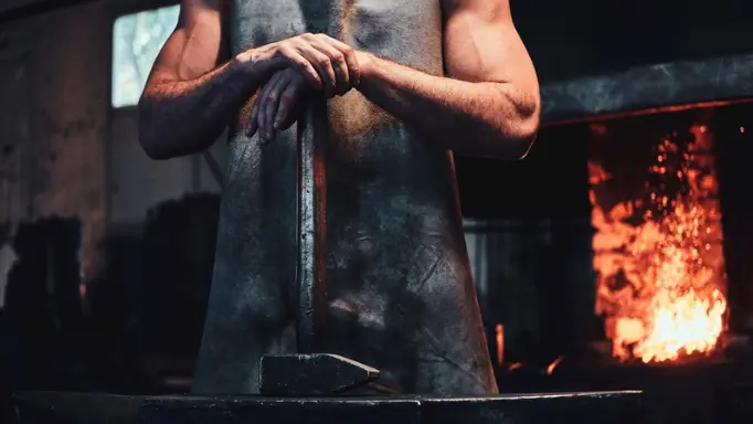 A hammer in the hands of a blacksmith