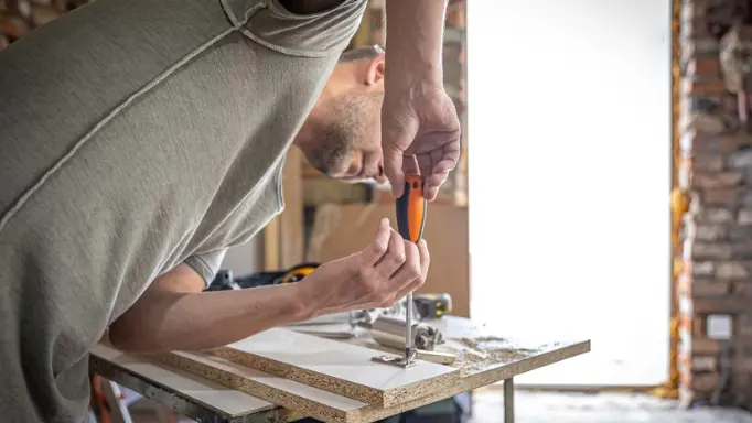  A man using hand tools in a DIY project