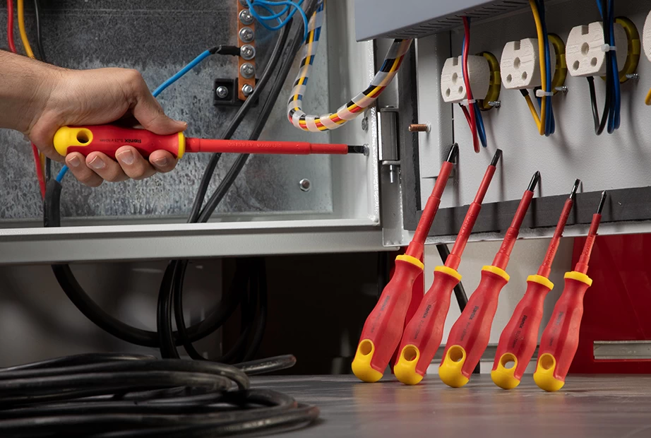 An Electrician using a Ronix screwdriver set