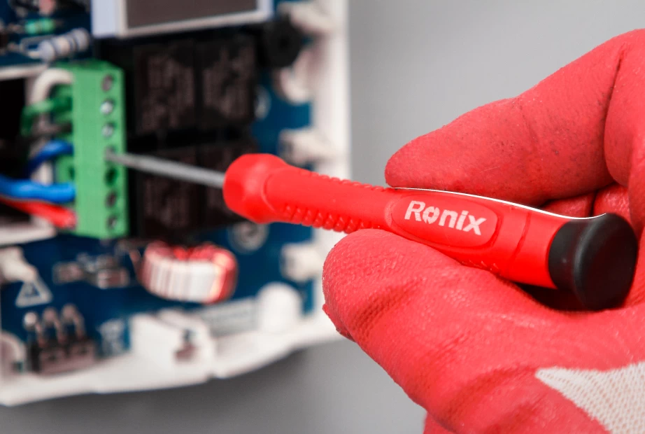 Using an insulated screwdriver on an electronic equipment