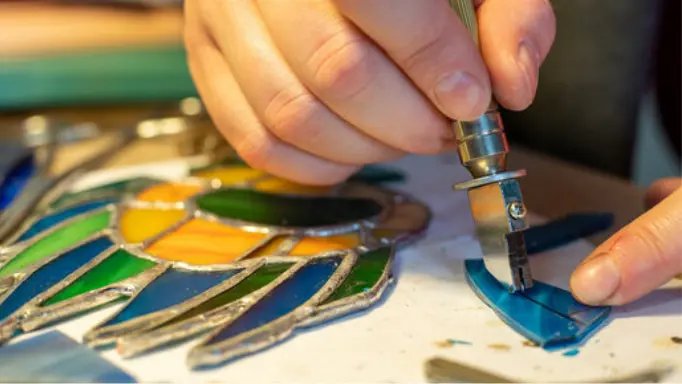 Cutting stained glass with a glass cutter