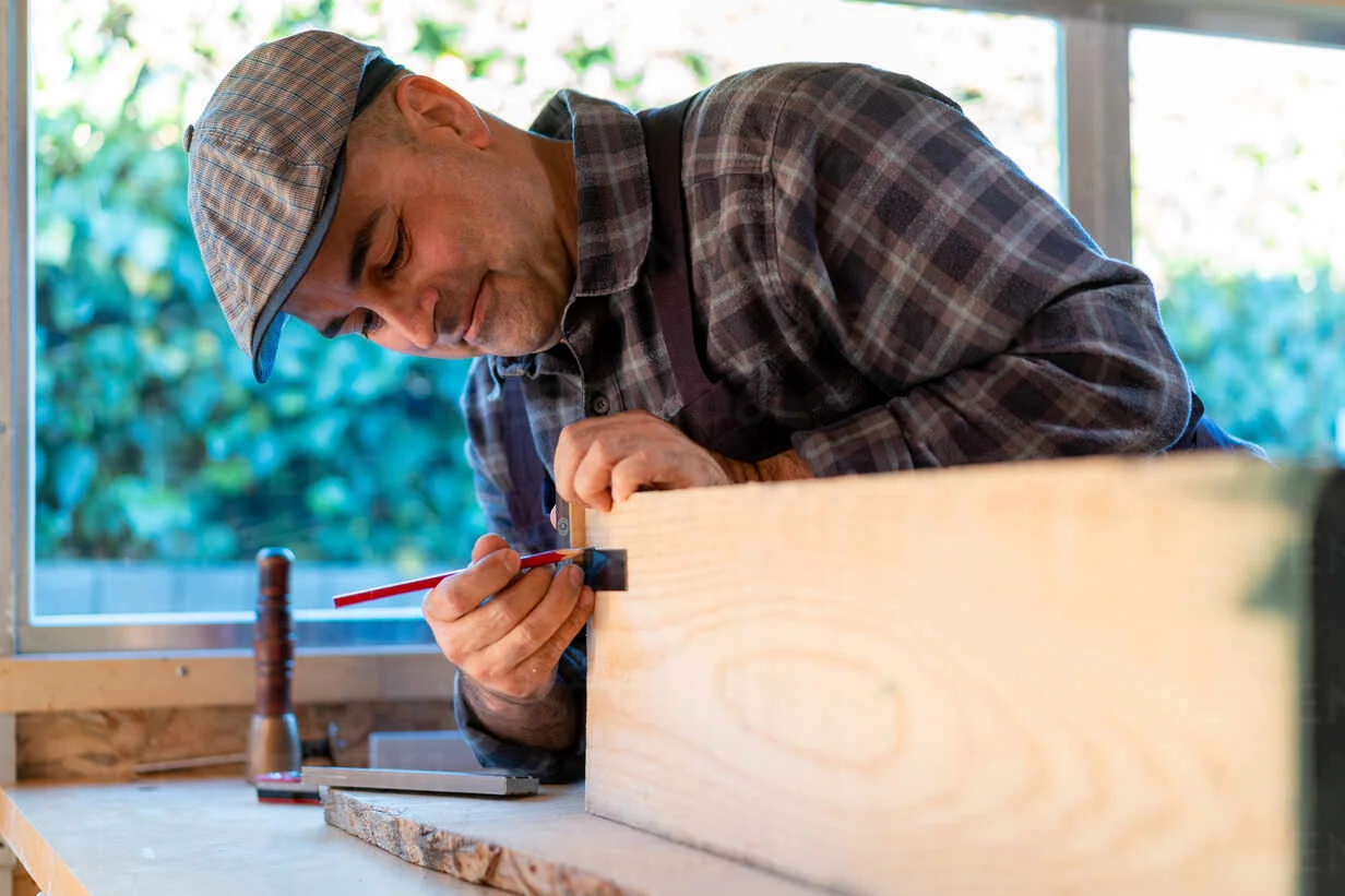 A man making a wooden toolboard