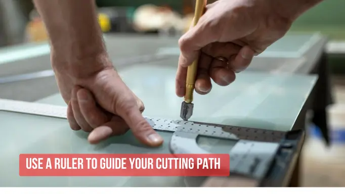 Using a ruler to guide the glass cutters cutting path