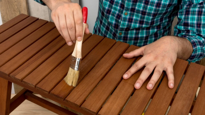 putting oil on a wooden table to make it waterproof