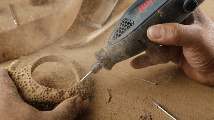 a rotary tool being used for wood carving
