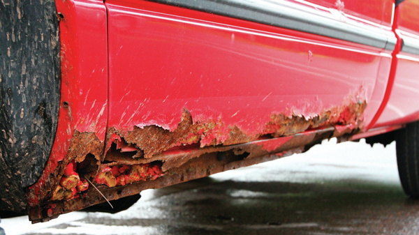 sanding a rusty car