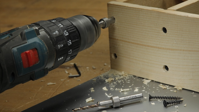 A drill is being used to turn a screw