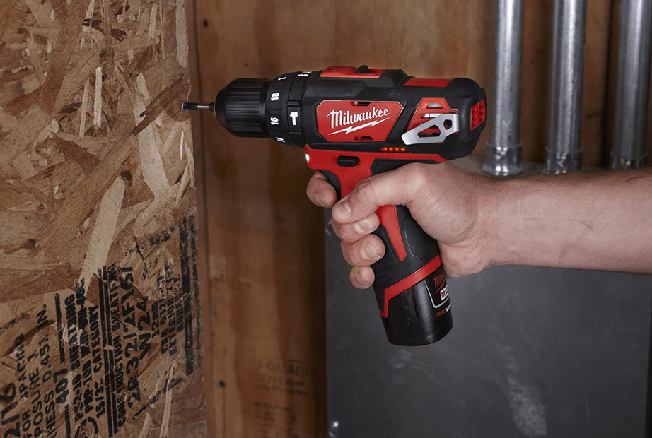 Drilling the wall using a Milwaukee cordless drill