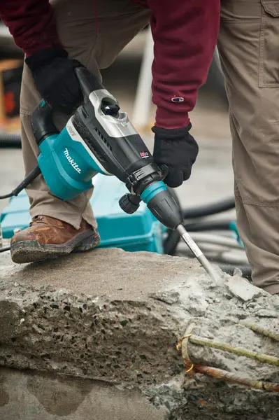 picture of a person using a Makita rotary hammer drill