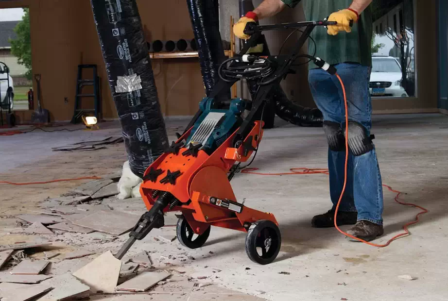 man using a power jackhammer to remove tiles