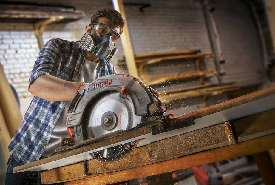 Ronix circular saw is being used to cut a wooden board