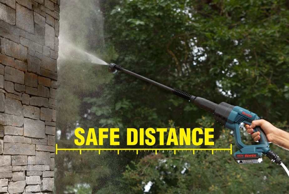 A man keeping the nozzle of his high-pressure washer at the right distance