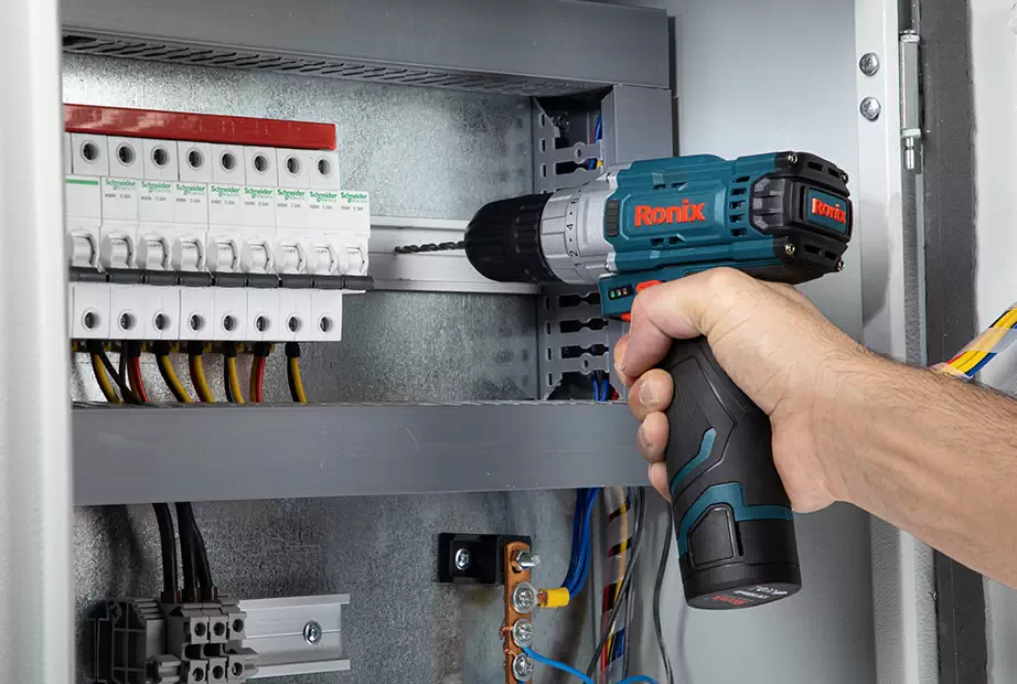 A cordless drill drilling in a Pdb (Power distribution board)