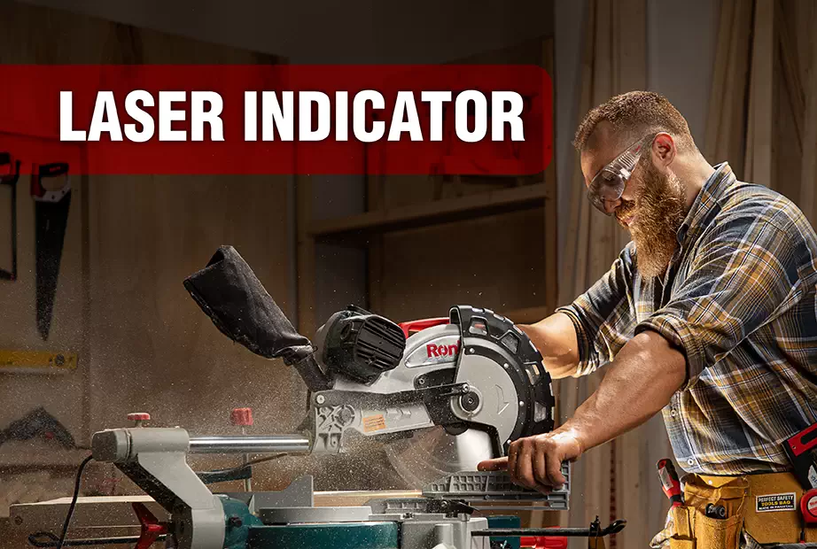 A man is operating a miter saw with laser indicator
