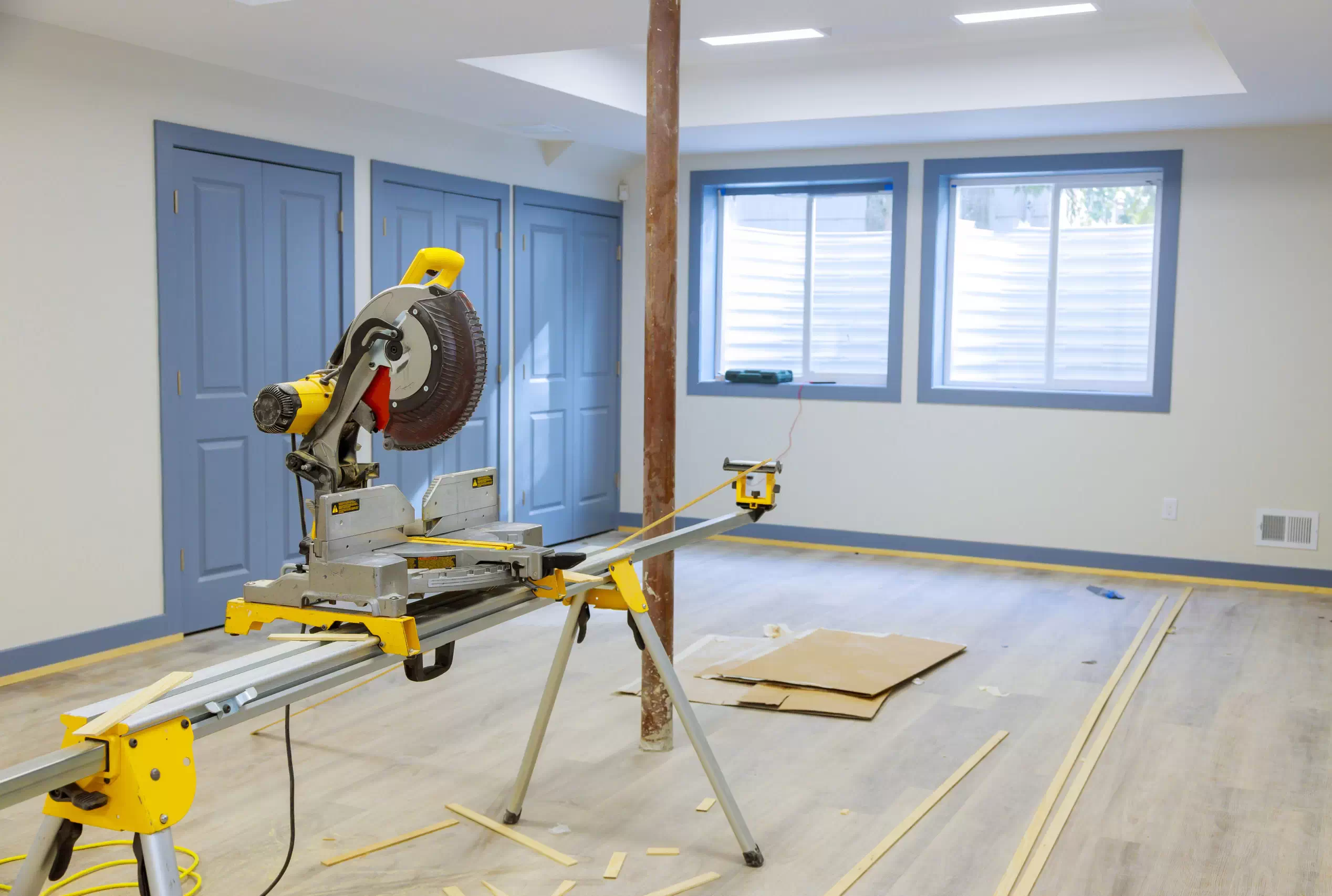  A trim work project with a miter saw in the middle of the room
