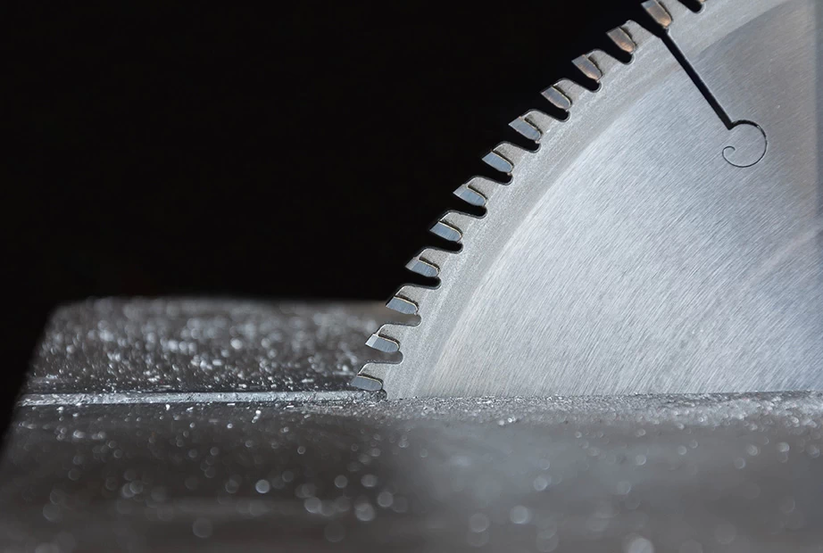 A non-ferrous metal saw blade cutting through aluminum