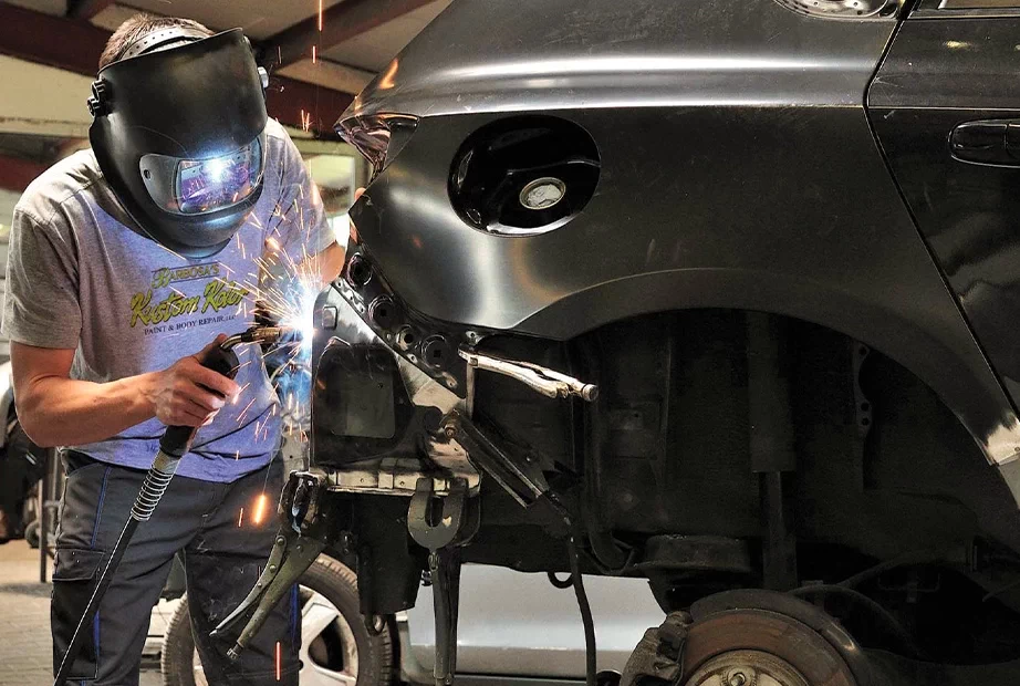 a man making joints on a car by welding