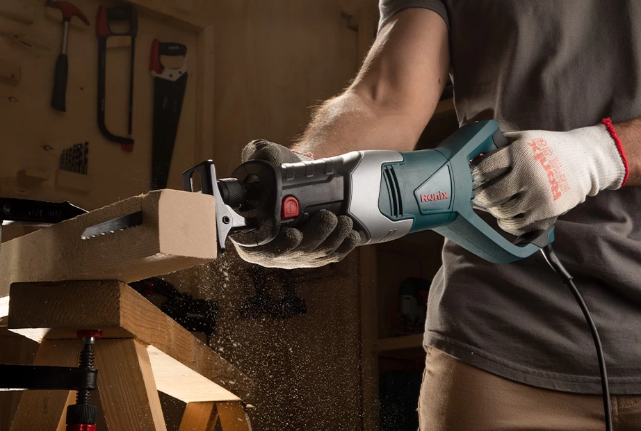A picture of a man using a Ronix reciprocating saw on wood