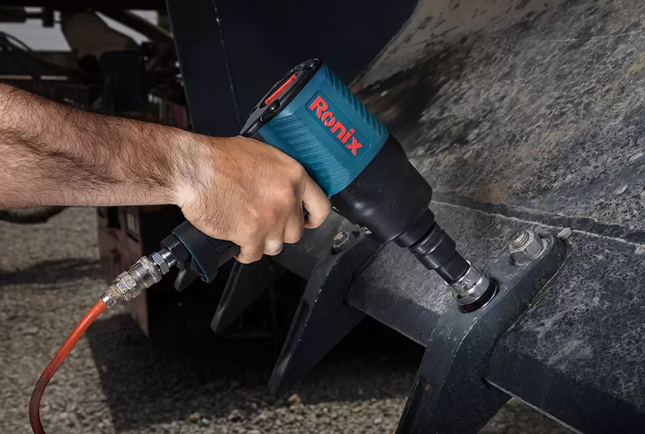 A mechanic using a Ronix air impact wrench