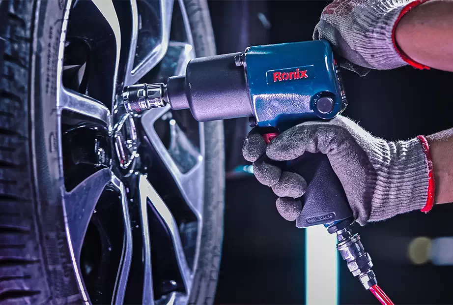 A mechanic using a Ronix air impact wrench to tighten a Vehicle Wheel Lug Nut