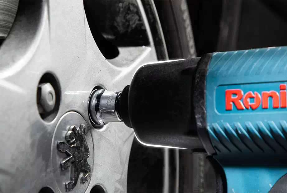 A picture of an air impact wrench with a focus on its 3/8” driver