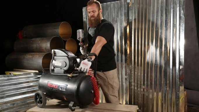 A Ronix compressor is being used to operate a paint gun