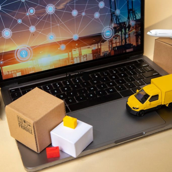 picture of a laptop and a truck toy on it
