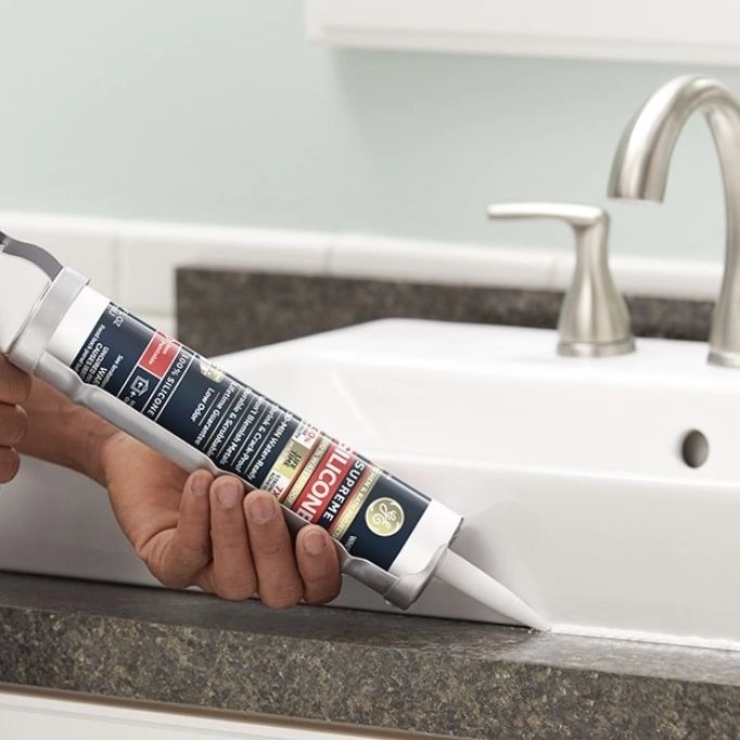 picture of a person using a gun in bathroom 