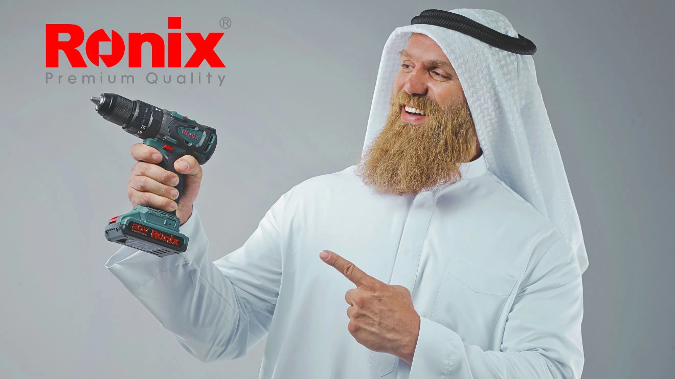 Happy Arab customer holding Ronix drill