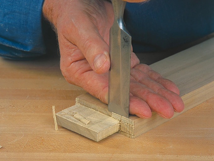 A bench chisel is being used