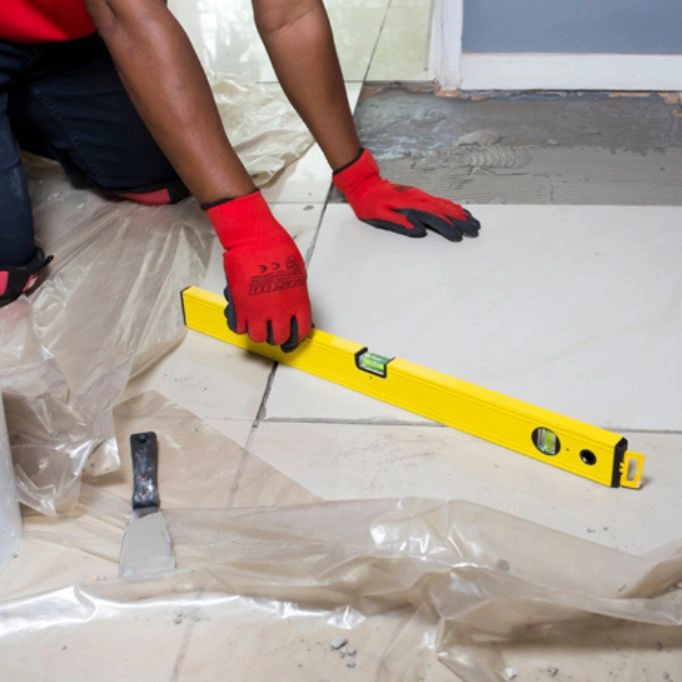 picture of a person using a spirit level for tiling 