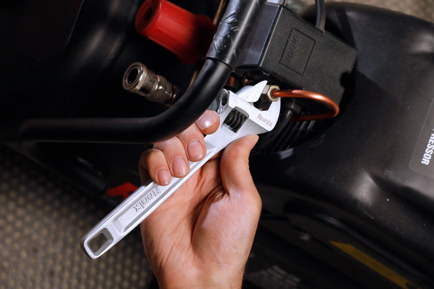 a person working with an ergonomic adjustable wrench