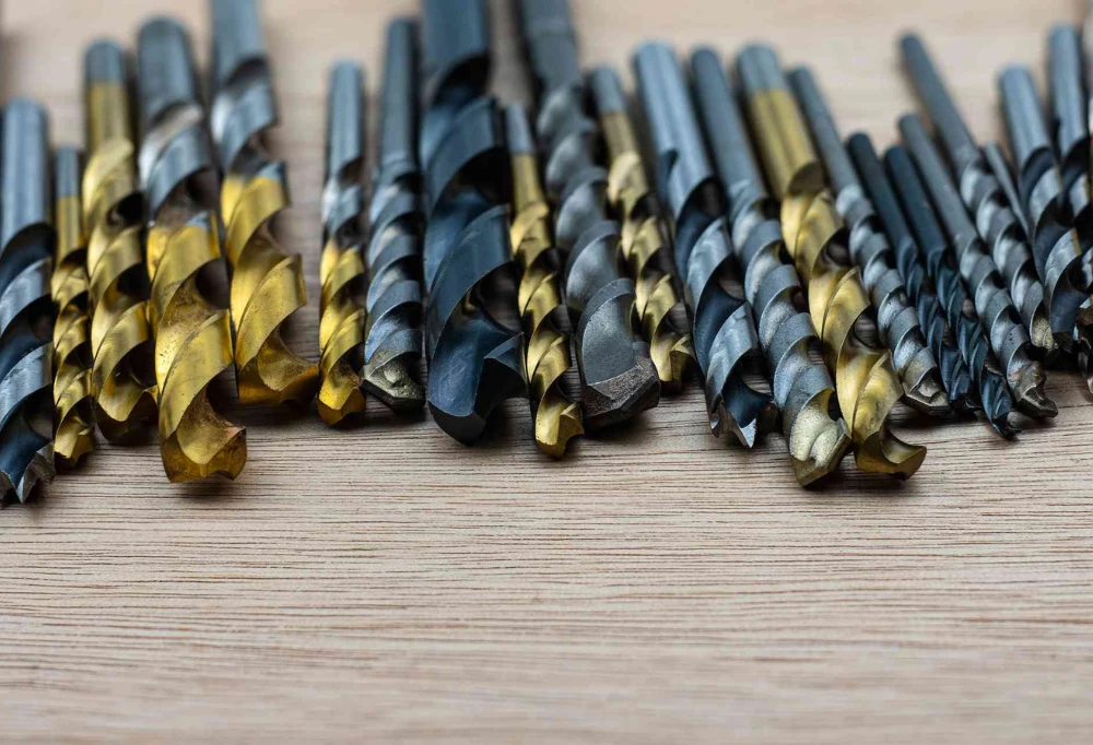 A series of drill bits on a table
