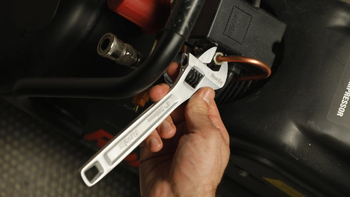  a small adjustable wrench being used