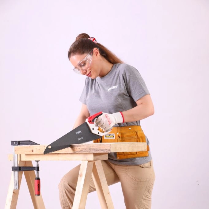 picture of a woman using a hand saw
